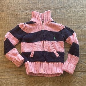 Ralph Lauren zip up sweater in a baby pink and navy blue stripe. Size 2T.